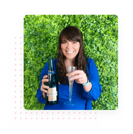 Woman smiling with a bottle of champagne